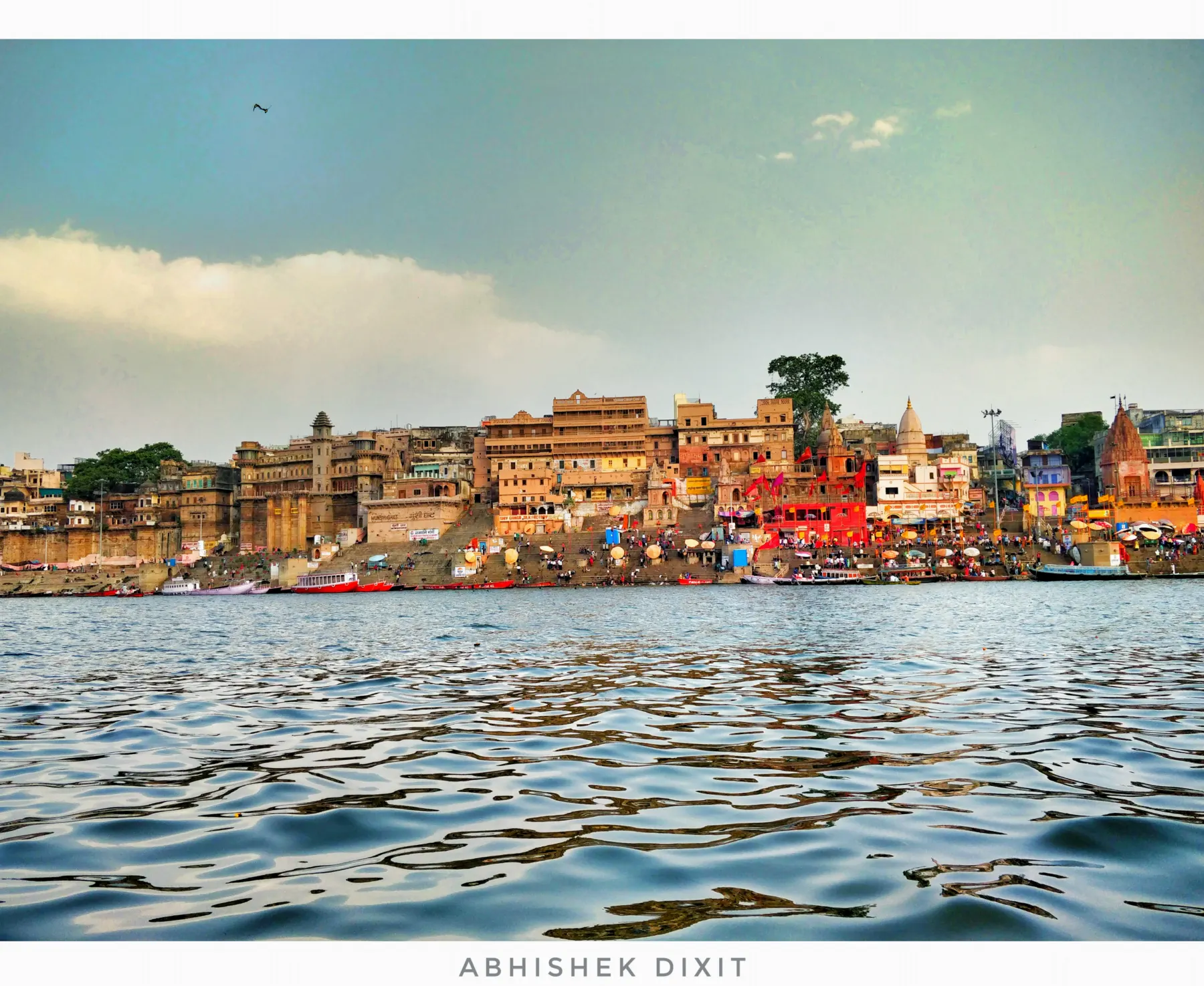 Palaces and temples along the ghats seen across the water