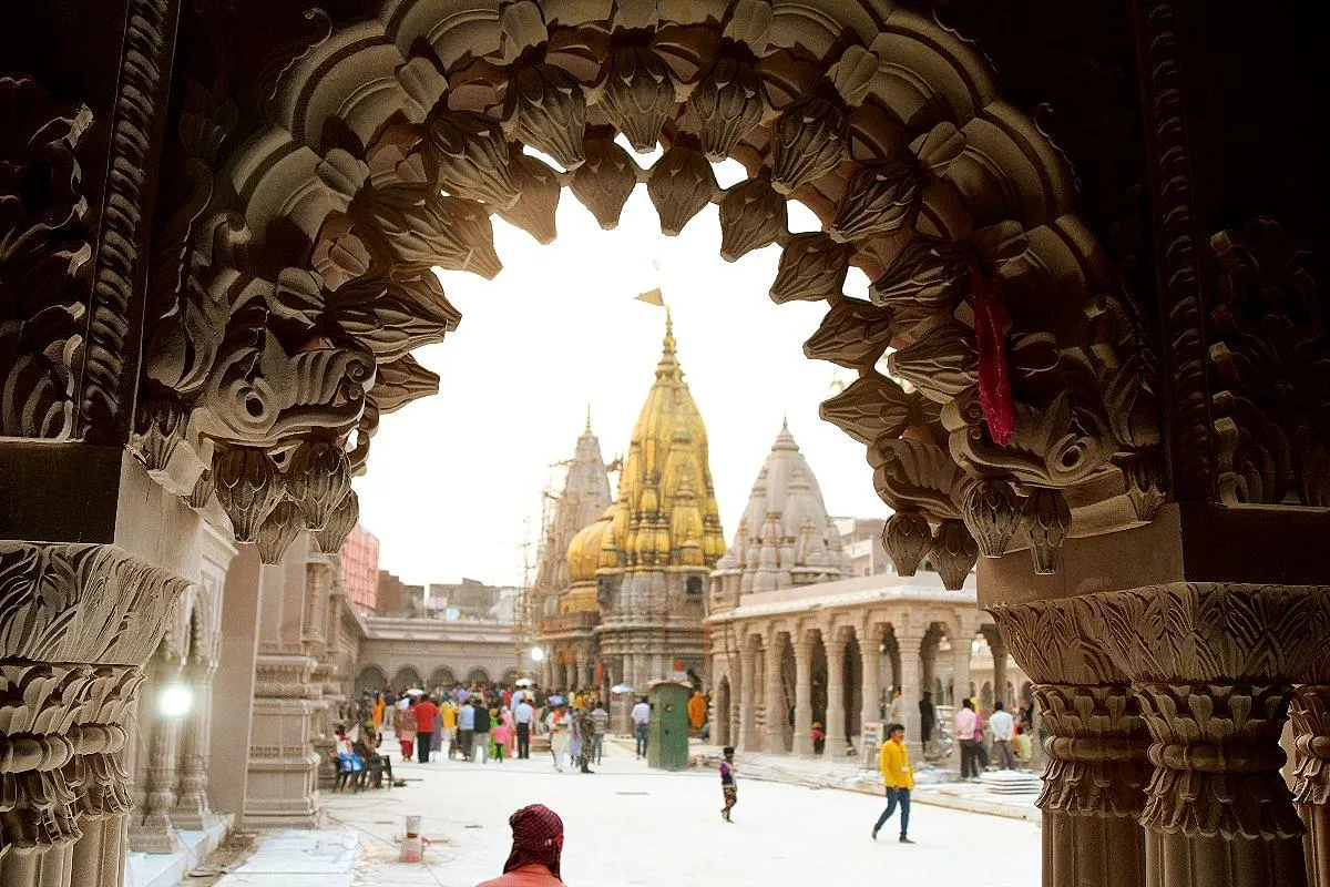 The Kashi Vishwanath temple framed by a carved stone arch in the Dham