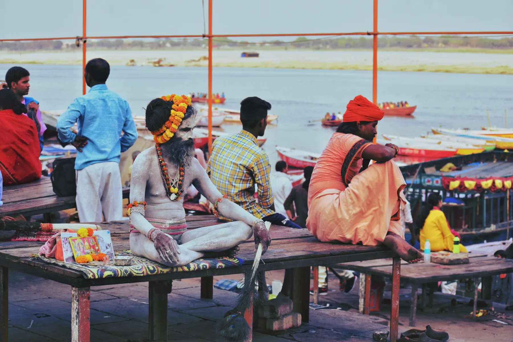 Sadhus and pilgrims gathered on a riverside platform